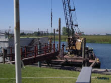 Tug boat and spud barge repairing dock pilings at Bethel Island